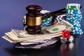 gavel on money and chips for poker debt collection lawyer