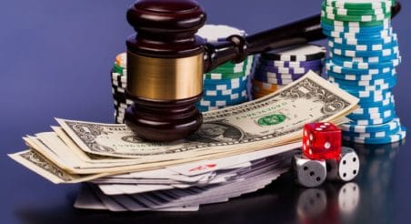 gavel on money and chips for poker debt collection lawyer