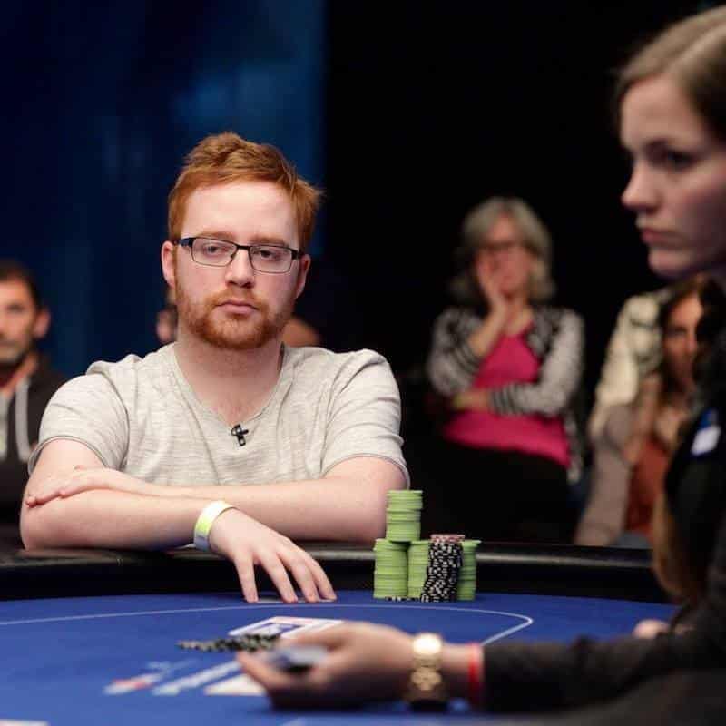 Niall Farrell Upswing Poker Coach sits at live MTT table with chips